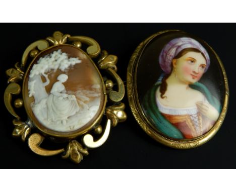 Two brooches, to include a cameo set brooch and an enamel portrait brooch, depicting a girl in dress with head scarf, each in