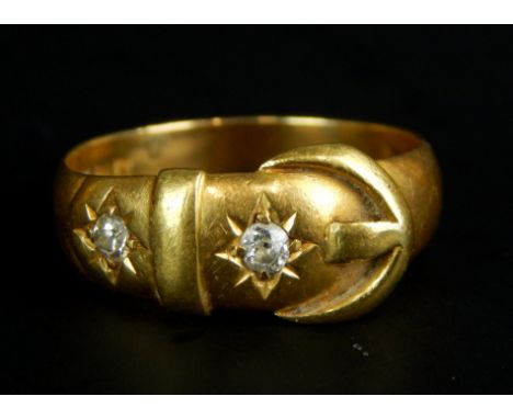 An 18ct gold buckle ring, set with two diamonds, 4.4g all in. 