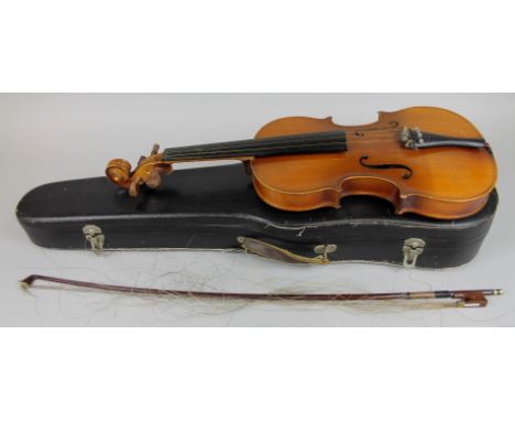 A Czechoslovakian Stradivarius violin, with two piece back, 35.5cm long, and a bow. 