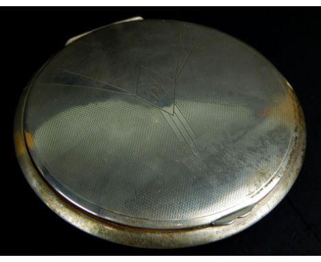 A large circular Art Deco compact, the engine turned lid inscribed Phyl, the underside of the base engraved with love from No