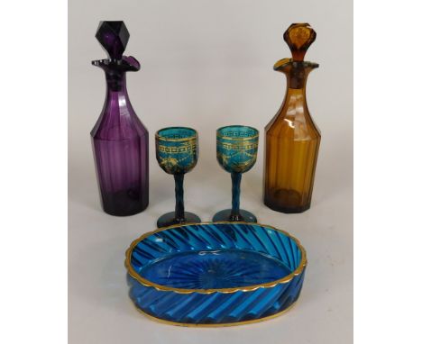 A 19thC amethyst glass decanter, another amber glass example, 30cm high, together with a blue glass oval dish and a pair of b