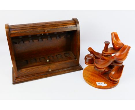 A tambour front lockable pipe rack, 27 cm x 36 cm x 13 cm and one further pipe stand. [2]. [W]