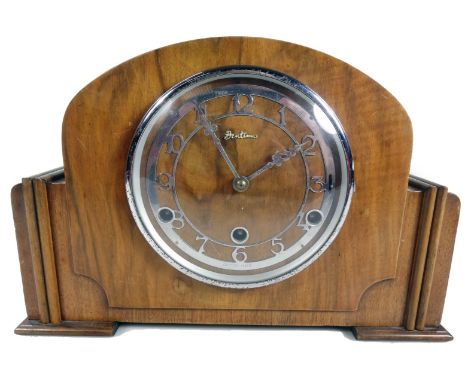 A 1950s walnut cased 8-day mantel clock, with chrome plated 13cm Dia. dial and three winding holes, with chiming movement in 