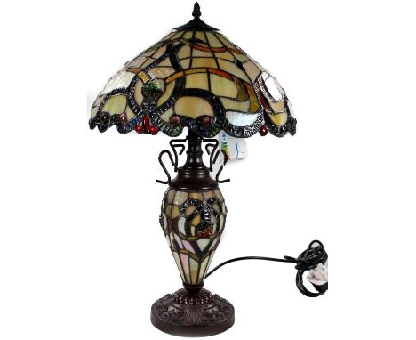 *An as new table lamp, with Tiffany style shade and stem, on a raised floral metal base, 67cm H.