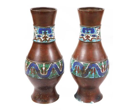 A pair of champleve enamel bronzed metal vases, each of bulbous form with an upper and lower geometric banding predominately 