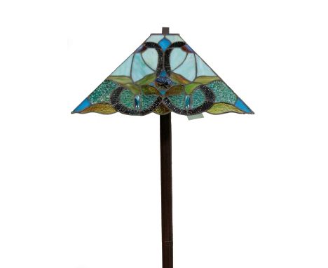 *An as new electrical standard lamp, with Tiffany style shade set with coloured glass sections on a turned stem and square su