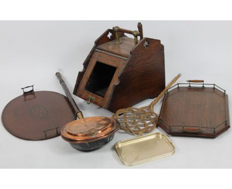 An Edwardian oak coal box, 45cm H, with central handle, carpet beater, two trays and a copper warming pan. (a quantity)From t