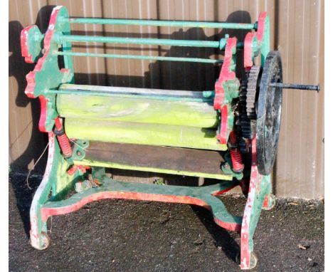 An early 20thC cast iron The Nelson mangle, with cylindrical wooden articulated centre and side handle, 74cm H, 88cm W, 48cm 