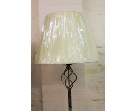 *An as new electrical standard lamp, on entwined cylindrical stem and circular foot, with shaped shade, 168cm H.