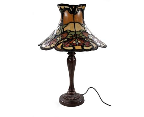 *An as new two branch table lamp, with Tiffany style shade decorated with flowers predominately in green and cream, 67cm H.