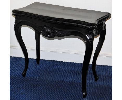 A Victorian ebonised serpentine card table, with shell frieze and cabriole legs, 88cm W.