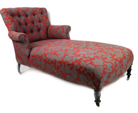 A 19thC day bed, upholstered in Iater floral material with a button back, scroll arms and turned forelegs terminating in cast