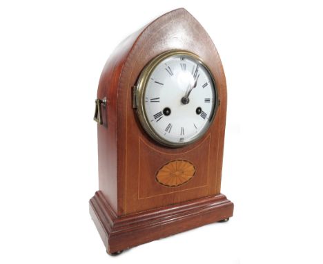 An Edwardian mahogany and boxwood strung mantel lancet clock, the raised 12cm Dia. Roman numeric and Arabic dial revealing an