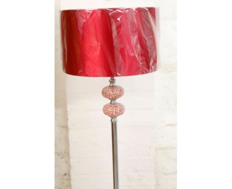*An as new electrical standard lamp, with cylindrical stem on circular foot, with circular shade in red, 156cm H.