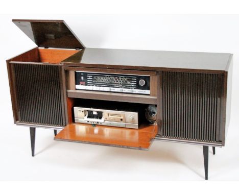 A vintage Grundig grammar phone radiogram, in rectangular cabinet with mesh front speakers on shaped supports, the hinged lid