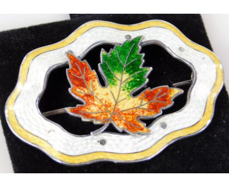 An early 20thC Canadian enamel guilloche brooch, in yellow, with maple leaf centre and pin back, 7cm W.
