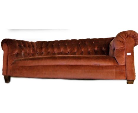 An Edwardian oak framed button back Chesterfield settee, in later button back pink material, on tapering legs, 190cm W. 