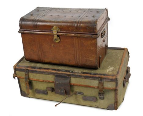 An early 20thC tin trunk, the domed top partially studded, with a plain interior, 37cm H, 55cm W, 37cm D and a travel case wi