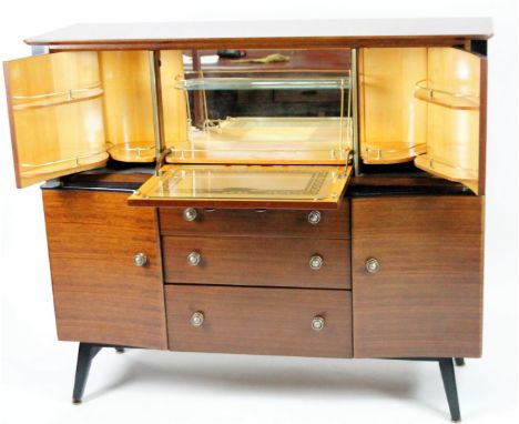 A vintage 1970s teak Beautilty cocktail cabinet, the overhanging top raised above an articulated section with concertina acti