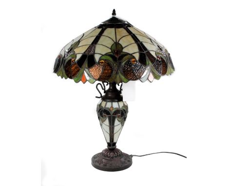 *An as new table lamp, with Tiffany style shade and stem on metal base, 64cm H.