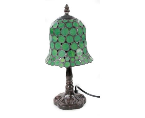 *An as new table lamp, with bell shaped shade decorated with circular sections in green, 36cm H.