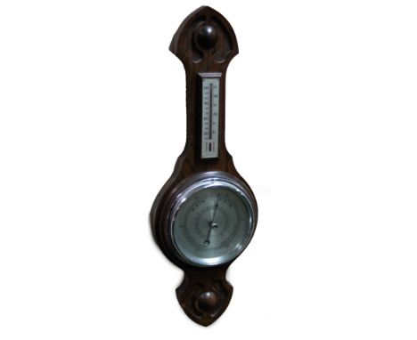 A 20thC oak stained barometer and thermometer, with 12cm Dia. dial in carved case, probably beech, 55cm H.  