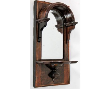 A late Victorian rosewood wall bracket, with arch hooded bevel mirror over shelf, 56cm H, 27cm W.