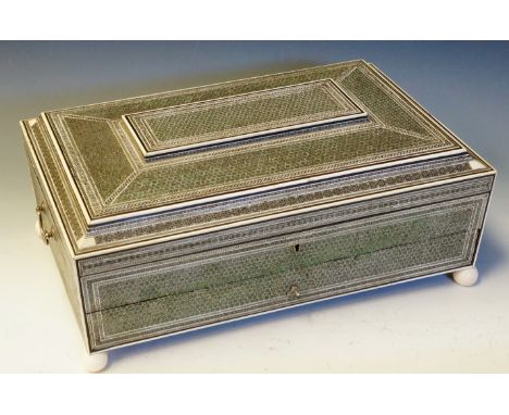 A good Vizagapatam sewing box of shallow sarcophagus form finely inlaid overall with parquetry motifs in silver coloured meta