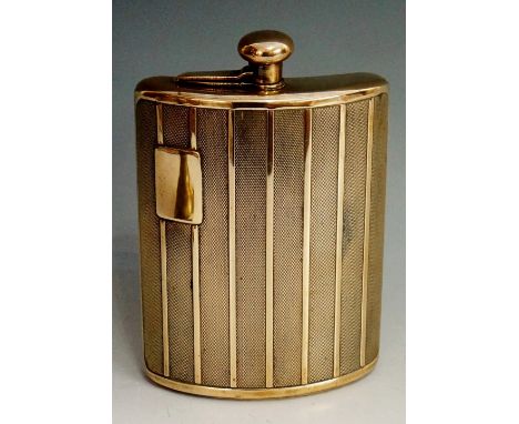 An engine turned "radiator grille" brass hip flask, the front with vacant rectangular cartouche, bun shaped hinged cover, 18c