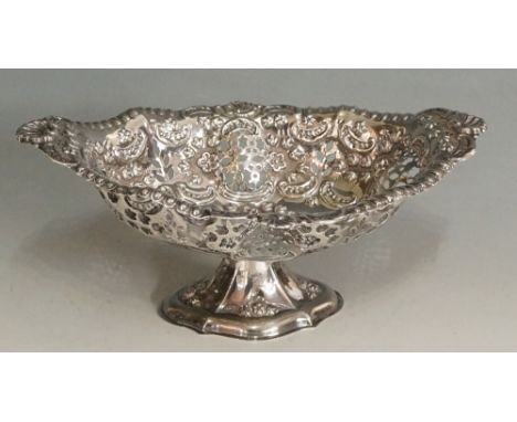 An oval sweetmeat dish, the body pierced, chased and embossed with scrolls and flowering foliage, the upper rim with shells, 