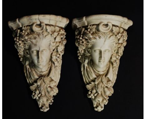 A pair of carved marble brackets the fronts with female masks flanked by ribbons, fruit and leafage, C-crescent to the centre