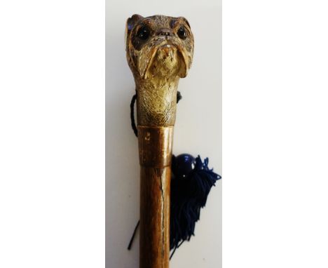 A Victorian walking stick, the handle carved and painted as a Boxer dog's head, eyelets for blue silk tassel, plain gilded me