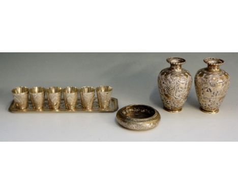 A selection of Indian ? silver coloured metal items to include: a pair of small vases, the bodies chased and embossed with pe