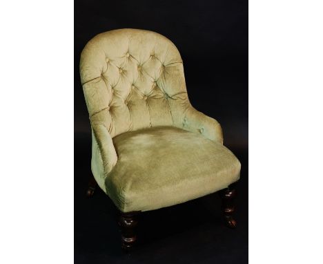 A Victorian mahogany button back nursing chair on turned fore legs fitted ceramic castors, 76cm high, Circa 1880
