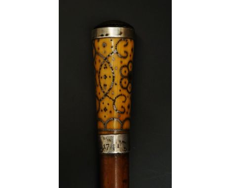 An 18th Century piqué handled walking stick, the top inlaid with gold and silver coloured metal cross hatching, the sides of 