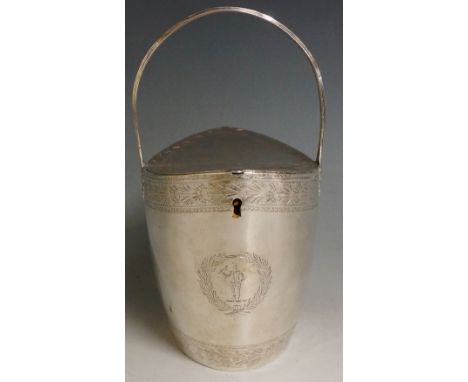 A George III navette shaped silver lidded basket with reeded handle, the double hinged lid with foliate engraved borders the 