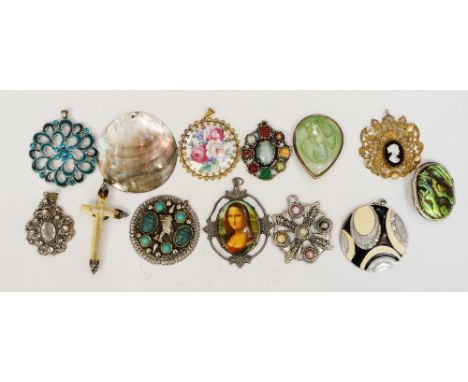 A selection of antique, vintage and modern pendants to include: a carved ivory crucifix with silver coloured metal mounts; an