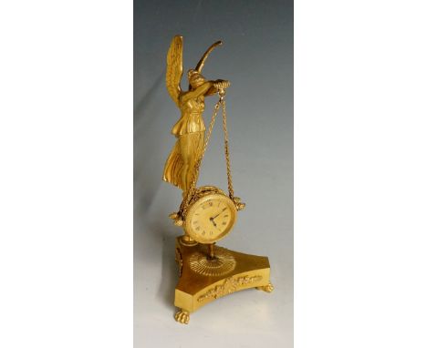 A 19th Century French  ormolu mantel clock the winged angel figure holding chains supporting a drum shaped case, cast two bor