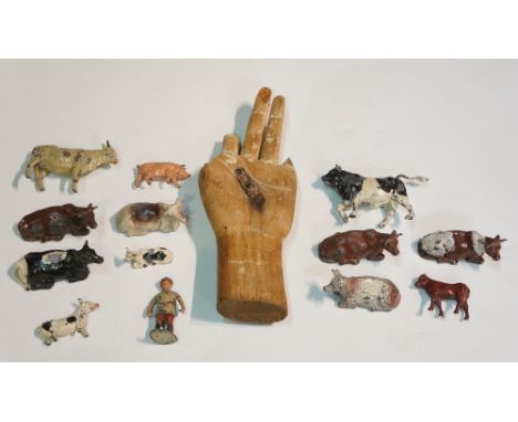 An 18th Century Chinese wooden hand, bearing traces of gesso decoration, 23cm long; a carved rootwood figure of a carp, 15cm 