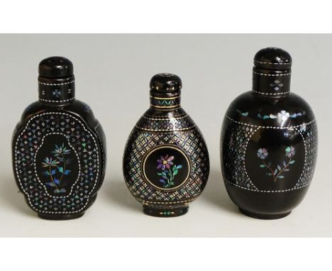 A collection of three Japanese lacquered snuff bottles, one decorated to each side with mother of pearl flowers within circle