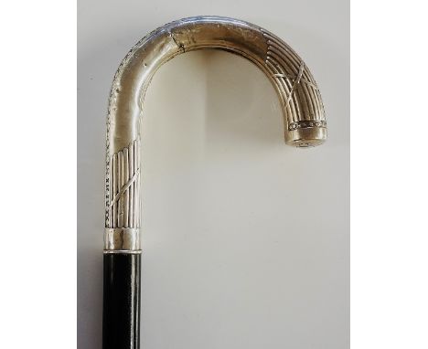 A 19th Century French crook handled walking stick, the handle chased and embossed with beads and lobes, marked 800, ebony sha