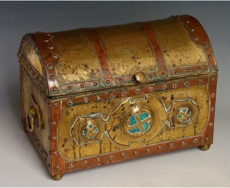 A 19th Century continental Arts & Crafts brass casket of dome trunk form applied copper studded bands the front with three bl