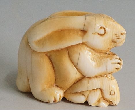 A Japanese ivory netsuke carved as a rabbit and kitten, 3.4cm high