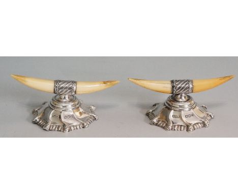 A pair of silver mounted polished bone knife rests, stepped spirally embossed circular feet, by James Dixon & Sons Ltd, Sheff