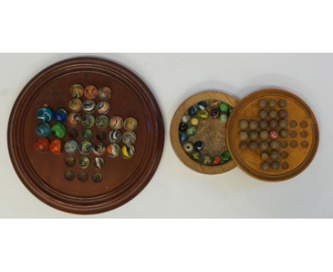 A mahogany solitaire board of conventional design with eighteen vintage marbles, 26cm diameter (incomplete); another cribbage