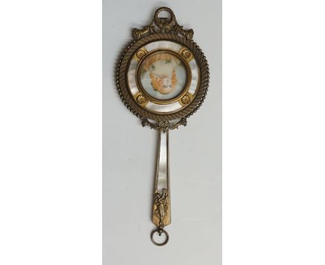 An Art Nouveau ormolu mounted hand mirror with mother of pearl decoration and central portrait of a red headed lady, laurel w