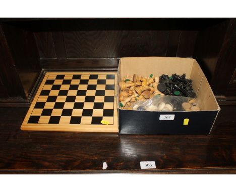 A Chad Valley chess board and a box of various chess pieces and draught pieces 