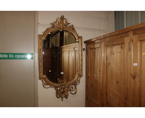 A French gilt framed bevel edged wall mirror, having three branch candelabra below AF