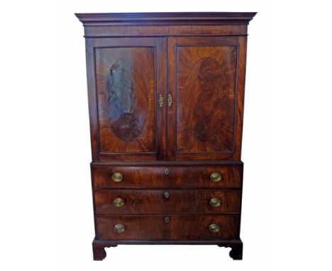 George III mahogany press cupboard, moulded corice above two single panel doors, each supporting oval veneers, interior with 