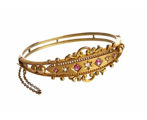 Victorian diamond and ruby Etruscan style gold bangle, 9ct gold oval hinged bangle, central panel set with 3 mixed cut diamon